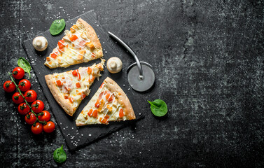 Chicken pizza slices and cherry tomatoes.