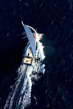 Nacira 67 designed by Axel de Beaufort. The result is a wide planning hull shape equipped with a canting keel, twin rudder direction system and a 30 m high rotating mast.