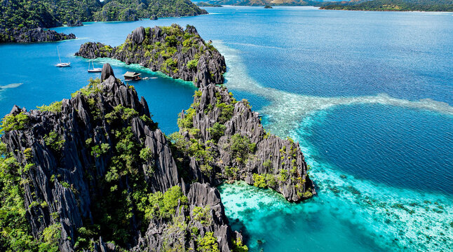 Aerial Drone Image of Karst Cliffs in Turquoise Water at Famous Twin Lagoon, Coron, Palawan, Philippines