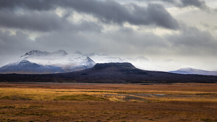 Elborg crater in Snaefellsnes Peninsula Iceland with snowy mountains in background - obrazy, fototapety, plakaty