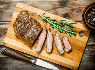 Grilled beef steaks with spices and rosemary.