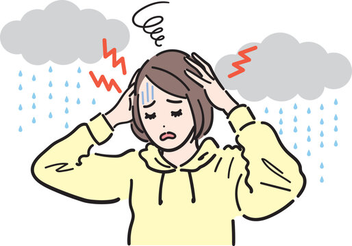 気象病による頭痛で悩んでいる女性