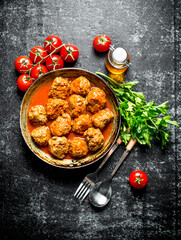 Meat balls with herbs and tomatoes.