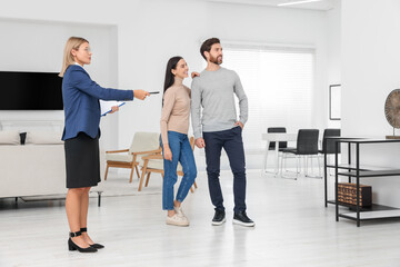 Real estate agent showing new apartment to couple