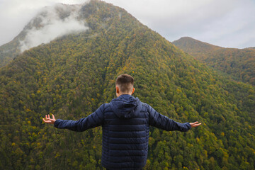 Man enjoying picturesque mountain landscape, back view