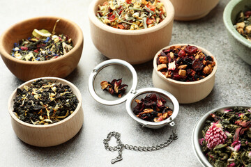 Many different herbal teas on grey table