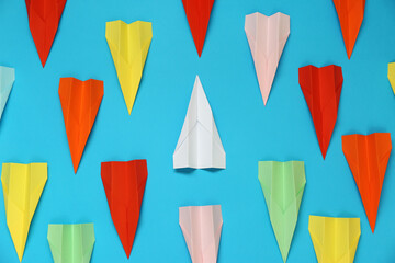 Flat lay composition with different paper planes on light blue background