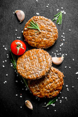 Cutlets with pieces of salt,rosemary and garlic.