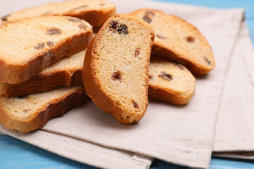 Sweet hard chuck crackers with raisins on light blue wooden table, closeup