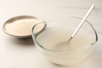 Agar-agar jelly and powder on white table, closeup