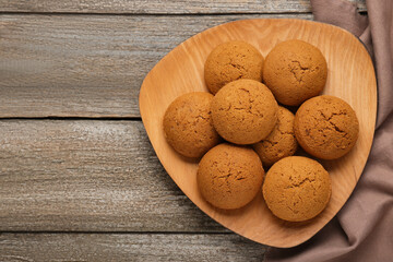 Delicious oatmeal cookies on wooden table, top view. Space for text