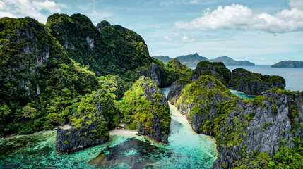 The Big Lagoon In El Nido, Palawan, Philippines. Kayaking In Shallow Crystal Clear Water, Turquoise Colored Reef, Bright Green Tree Covering Cliffs