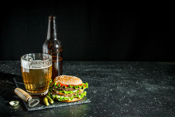 Beef Burger and beer in a glass and bottle.