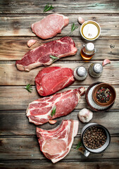 Raw meat. Beef steaks and pork with spices.