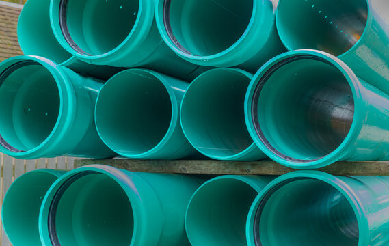 Stacks of green PVC water pipes. PVC water pipes used for construction