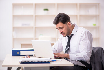 Young male employee working in the office