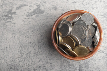 Coins in wooden cup.Future saving money concept.Copy space.