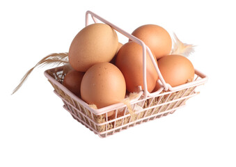 Raw chicken eggs in a basket on a white background