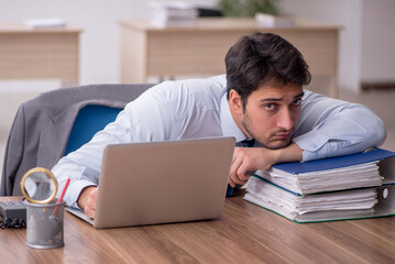 Young male employee working in the office