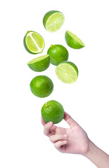 Hand hold lime with limes slices levitate in the air isolated on white background.