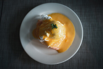 Delicious breakfast, egg benedict with smoked salmon on white dish
