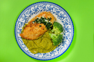 Balanced diet, keto diet. green pea puree, chicken breast with grilled vegetables, mushrooms and paprika. The concept of sports nutrition in disposable eco dishes, top view.