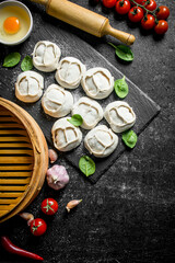 Raw manta dumpling with a rolling pin and a steamer.