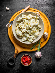 Obraz na płótnie Canvas Dumplings with tomato paste, garlic and rosemary.