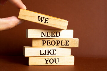 Wooden blocks with words 'We Need People Like You'.