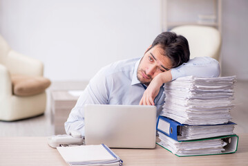 Young male employee working in the office