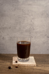 Coffee is placed in the cup on the wooden table. The hot coffee that emits fragrance after drinking will wake you up.