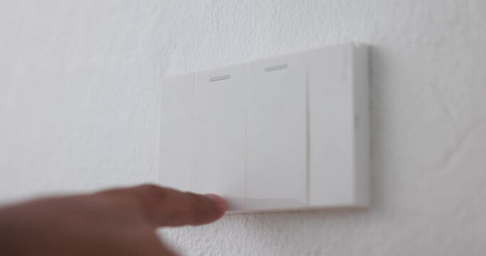 Close-up, male hand pushing switch to turn off the light for home lighting. 4k video footage.
