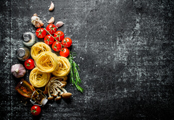 Tagliatelle raw with oil, garlic, tomatoes and spices.