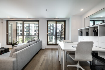 Fototapeta na wymiar Luxury modern apartment in condominium in Montreal perfectly staged and furnished with amentinites common areas swimming pool, rooftop, terrace, gym, garden and city views