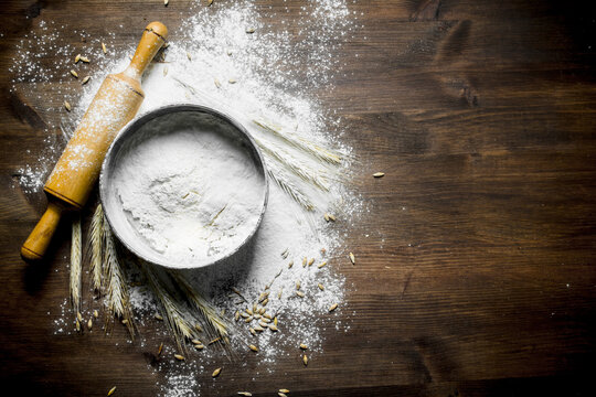 Flour with a sieve, rolling pin and spikelets.
