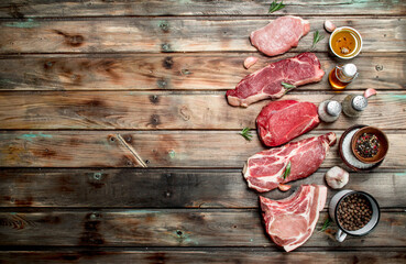 Raw meat. Beef steaks and pork with spices.