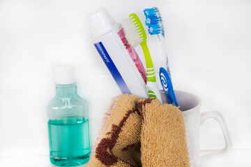 mouthwash, toothbrush, toothpaste health care for oral cavity with terry cloth arrangement flat lay style on background white 