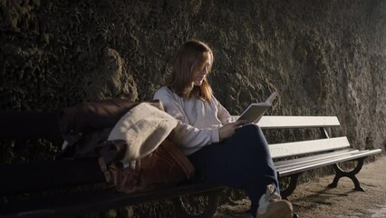 Girl reading on park bench meets up with boyfriend for a romantic date
