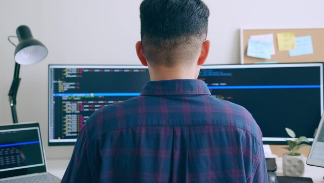 Young Asian man, developer programmer, software engineer, IT support, working on computer to check coding in bugging system
