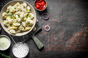 Dumplings with beef, tomato paste and sour cream.