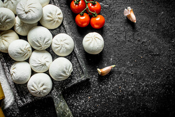 Raw manta dumplings with tomatoes on a branch.