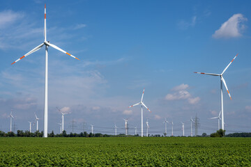 Wind turbines with power lines in the background seen in Germany