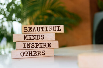 Wooden blocks with words 'Beautiful Minds Inspire Others'.