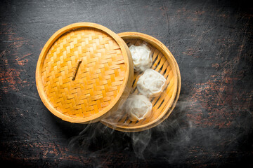 Hot dumplings manta in a bamboo steamer.
