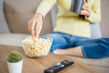 Asian woman Watching smart TV and using remote controller Hand holding television audio remote control at home with the remote control television