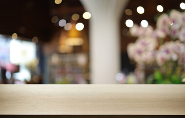 Wood table top in front of abstract blurred background. Empty wooden table space for text marketing promotion. blank wood table surface copy space