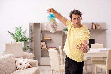 Young man doing housework indoors