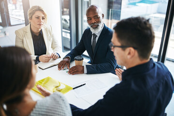 Business people, meeting and team discussion for strategy, marketing or collaboration at the office. Group of employee workers in business meeting, teamwork or coaching for sales at the workplace