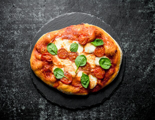 Homemade pizza with spinach.