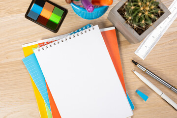 Notebook mockup with school stationery on a wooden table. back to school concept. Blank notepad with copy space. list of goals and plans for new year 2023